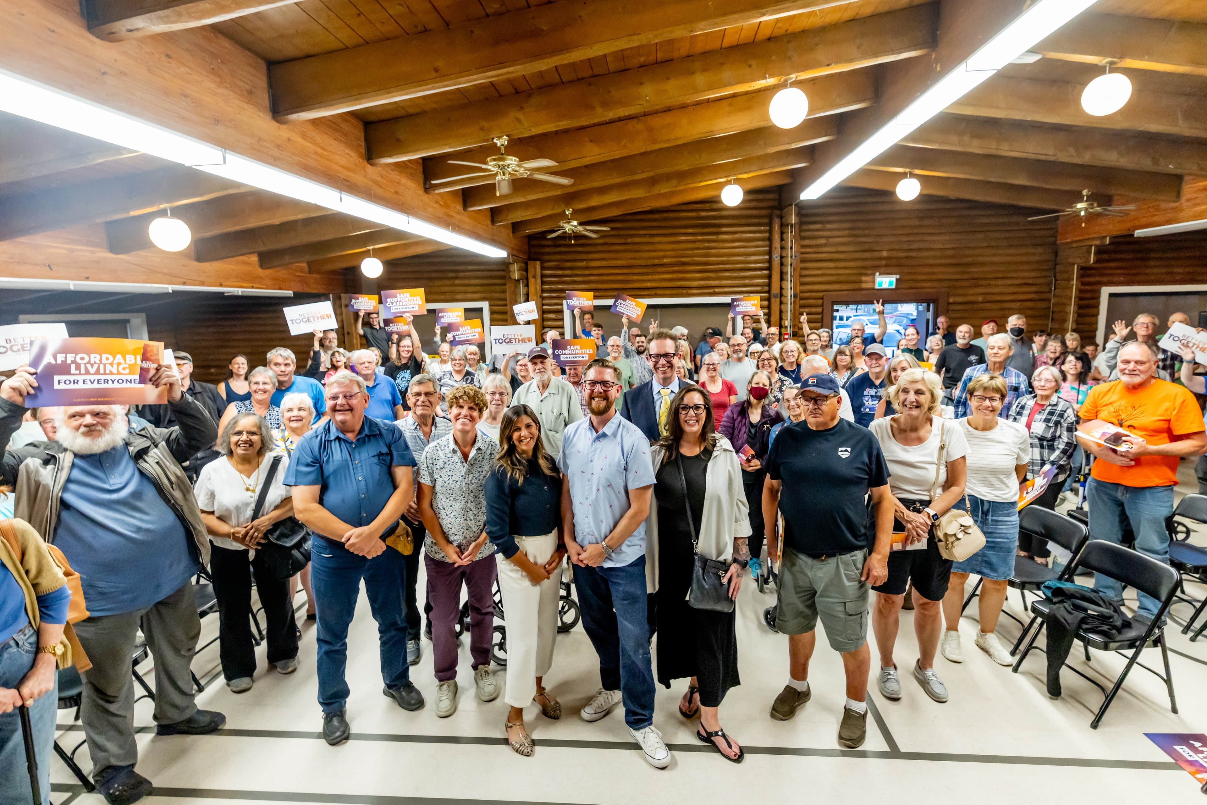 A group photo capturing MLAs and dozens of attendees at the Better Together Town Hall in Sherwood Park.